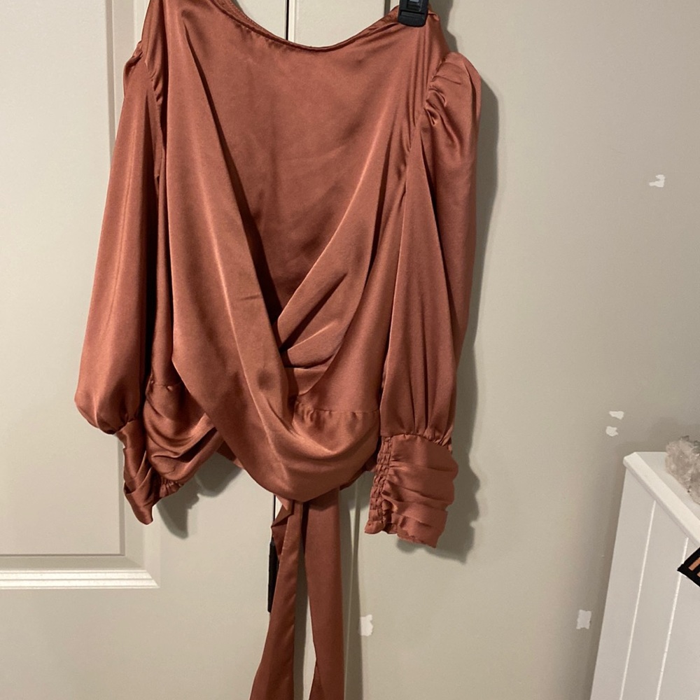 A cropped-ish top that is a dark pink with brown